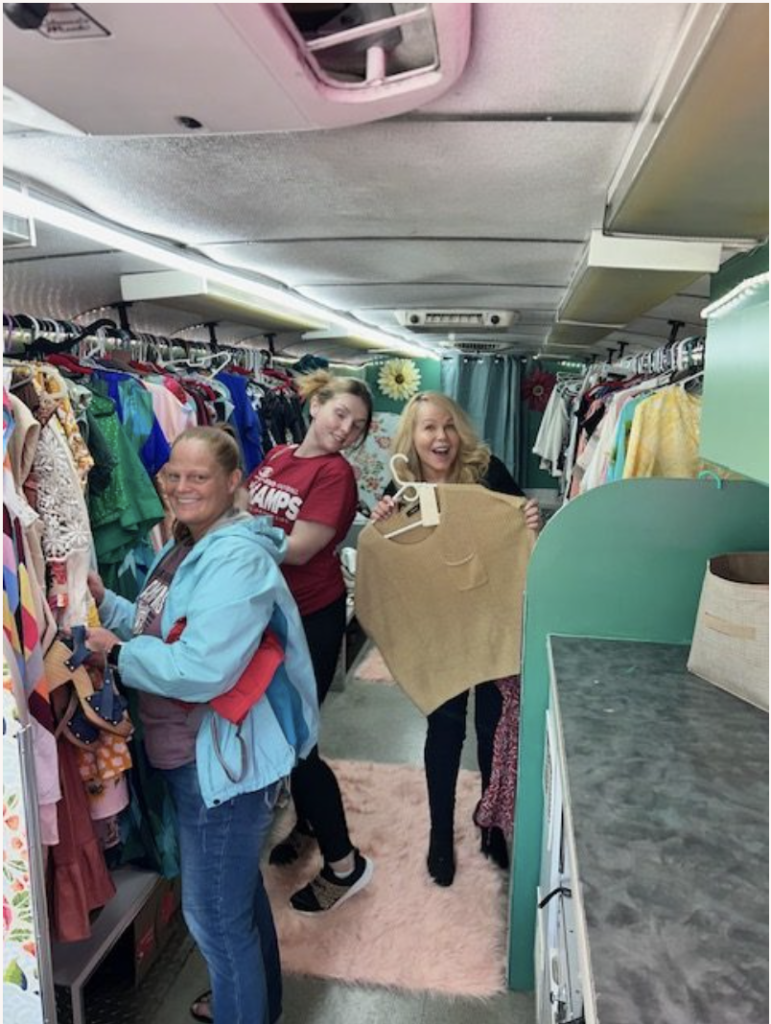 Women shopping on the Faith + Wildflowers Hope Bus